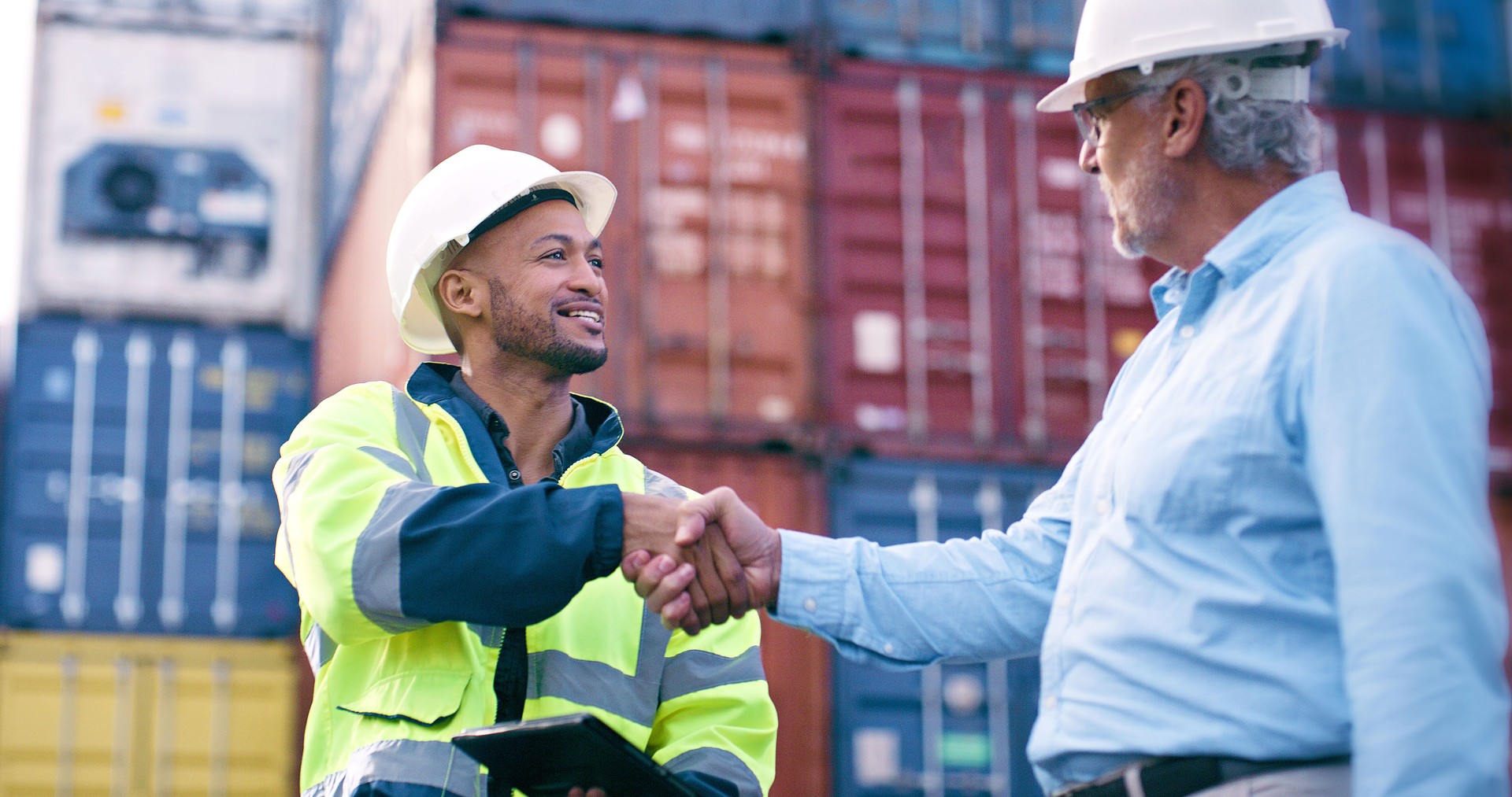 Happy, people or handshake for container business at industrial cargo, shipping or freight supply chain. Delivery manager, partnership and logistics worker in outdoor distribution trade port for deal